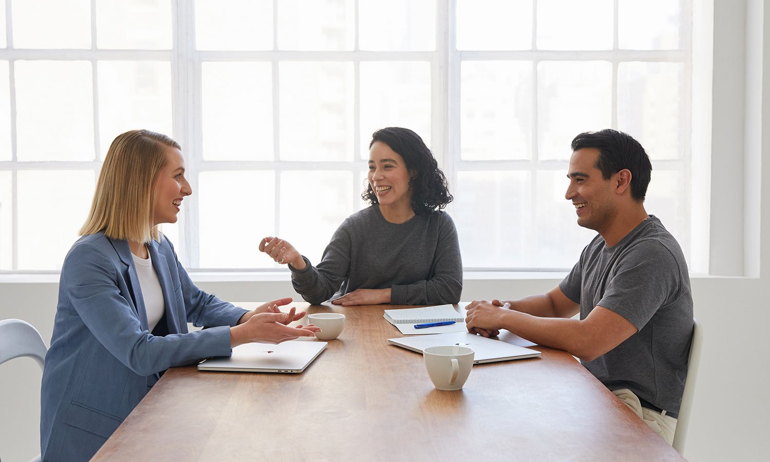 A financial advisor having a meeting with a couple at a table.