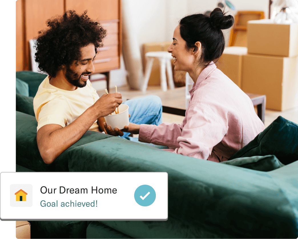 Two people celebrating in their newly purchased home next to a card showing our dream home goal achieved.