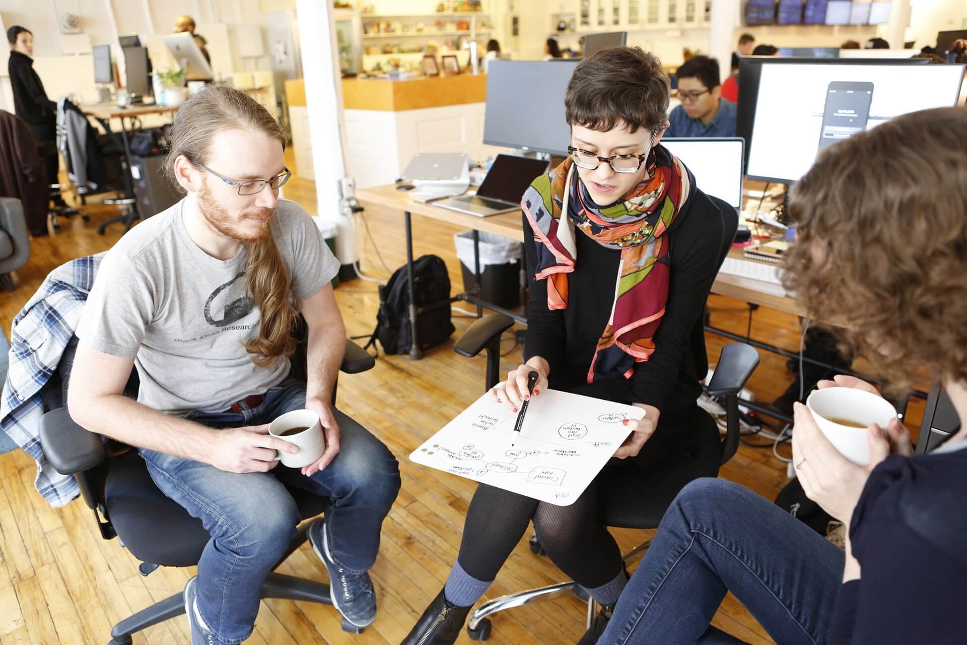 Engineers sitting together collaborating on a prroject.