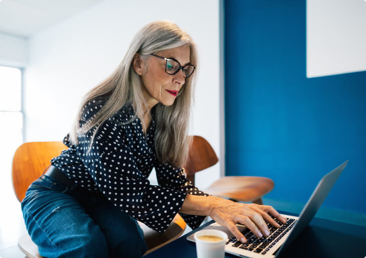 A woman using a laptop.